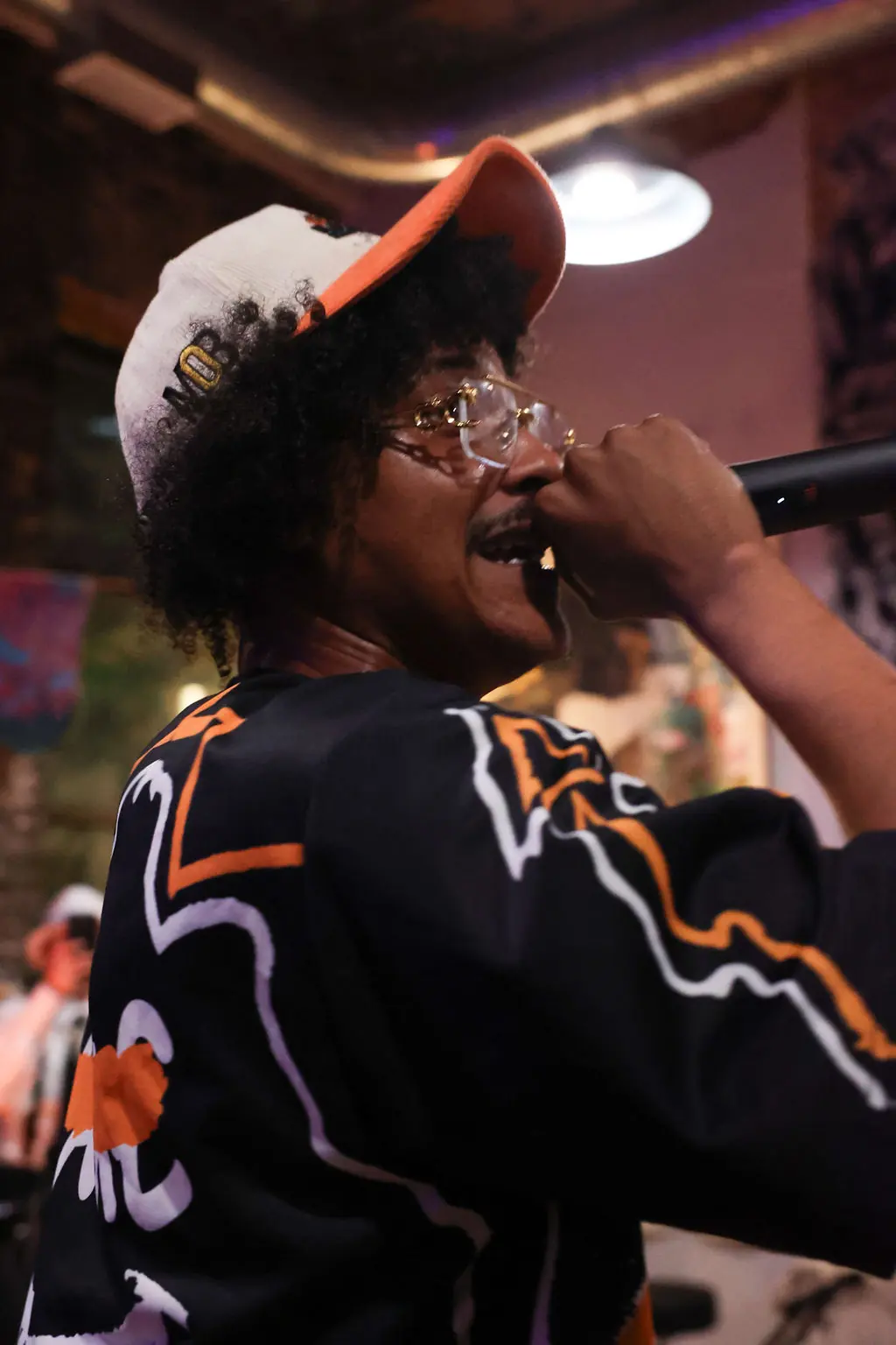 A vocalist singing into a microphone at a live event
